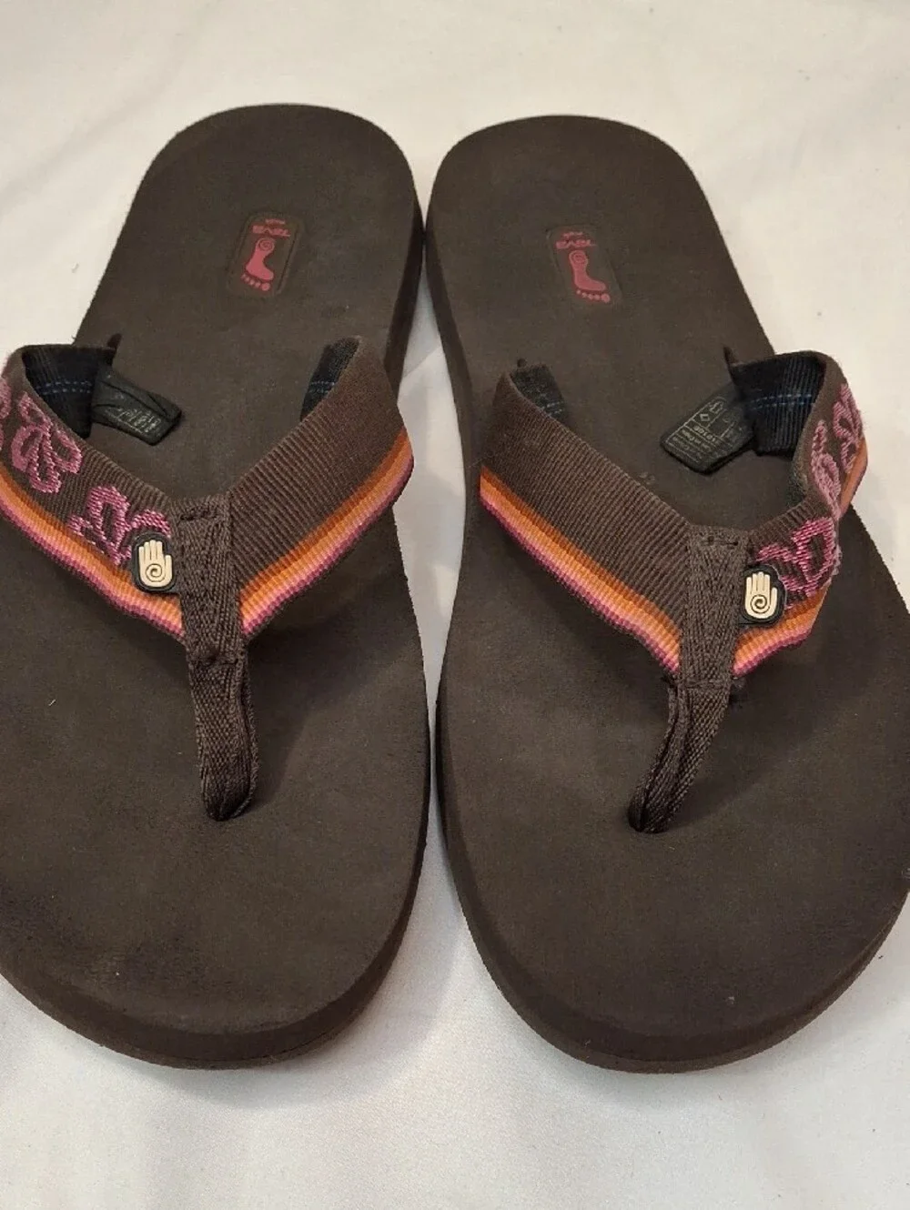 Teva Men's Brown Thong Flip Flops with Mauve and Orange Accents.Lightly Worn